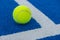 paddle tennis ball at the corner of the lines of a blue paddle tennis court