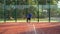 Paddle tennis expert player takes a serve and runs fast towards the net.