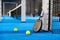 Paddle tennis racket, ball and net on the court