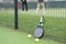 Paddle tennis racket, ball and net on the grass