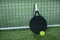 Paddle tennis rackets and balls on artificial grass