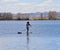 Paddleboarder on a lake in springtime