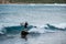 Paddleboarder riding a wave at Losari in Corsica