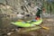 Paddler pumping up  inflatable whitewater kayak
