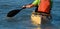 A paddler races his ocean kayak