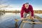 Paddling canoe on calm lake