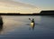 Paddling canoe at sunset