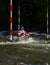 Paddling canoe in a whitewater slalom race