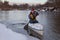 Paddling canoe on a winter river