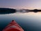 Paddling in a kayak through calm sunset waters