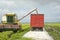 Paddy crops falling onto cargo truck from harvesting machine