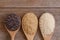 Paddy rice, riceberry ,brown coarse rice and white thai jasmine rice in wooden spoon  isolated on old rustic wood table