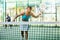 Padel game - woman with partners plays on tennis court