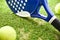 Padel rackets on outdoor artificial grass and balls