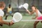 Padel racquet in hand of male player swinging to hit ball