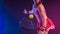 Padel tennis player with racket on tournament. Girl athlete with paddle racket on court with neon colors. Sport concept