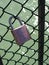 The padlock as a symbol of love is hanging on the railing of a bridge