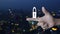 Padlock flat icon on finger over blur colorful night light modern city tower and skyscraper, Technology internet security and safe