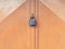 Padlock hang on locked garage doors in red color on the shabby wall