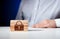 Padlock icon carved on wooden blocks with a businessman on the background. Technological security or safety