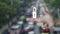 Padlock icon on finger over blur of rush hour with cars and road in city, Technology internet security and safety online conc