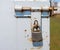 Padlock on partly rusted metal latch.