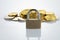 Padlock with a pile of coins in the background - secure banking concept