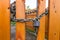 Padlock and steel thick chain on a bright wooden fence