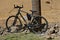 Padlocked bike to a post next to road construction