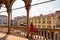 Padua -  Tourist woman enjoying the view on Piazza delle Erbe from the loggia of Palazzo della Ragione in Padua, Veneto, Italy