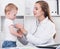 Paediatrist woman is listening child with a stethoscope