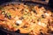 Paella - Mouthwatering Spanish seafood paella in a cast iron pan