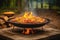 paella pan over crackling campfire flames