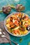 Paella with seafood. Traditional spanish food closeup on wooden table.