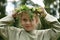 Pagan ritual, close-up portrait of a child girl with a wreath in the forest