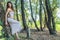 Pagan woman resting against the willow tree in the forest