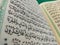 page on the contents of the Koran with Arabic writing with a blur effect