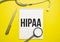 Page with HIPAA The Health Insurance Portability and Accountability Act of 1996 on the table with stethoscope, medical concept