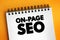 On-page SEO - process of optimizing pages on your site to improve rankings and user experience, text concept on notepad