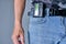 Pager hanging from man jeans belt, retro gadget for communication