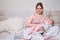 Pain and problems in a woman while breastfeeding a baby. Mother experiences discomfort while breastfeeding