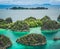 Painemo, Group of small island in shallow blue lagoon water, Raja Ampat, West Papua, Indonesia