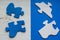 Paint. Blue and white puzzle pieces on an old wooden table