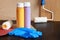 Paint bottles, paint roller, blue gloves and sandpaper