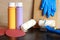 Paint bottles, paint roller, blue gloves and sandpaper