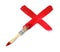 Paint brush making gouache red cross mark on white background