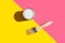 Paint brush with wooden handle can of varnish on trendy duotone pink yellow background. Interior design home refurbishing fashion