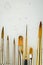 Paint brushes lined up on backdrop close up