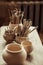 Paint brushes with pottery tools in bowls on table