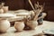 Paint brushes with pottery tools in bowls on table